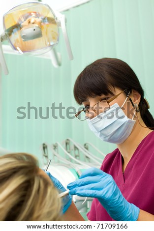 Female Dentist Wth Protection Mask And Gloves Working On Patient Stock ...