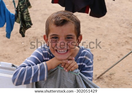 KHANKE REFUGEE CAMP, DOHUK, KURDISTAN, IRAQ - 2015 JULY 30 - Unidentified refugee smiling in Khanke (khanke) camp near Dohuk in Northern Iraq