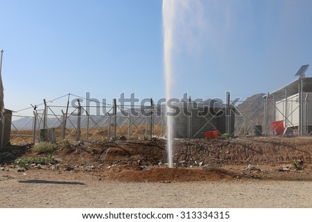 RWANGA REFUGEE CAMP, ZAKHO, KURDISTAN, IRAQ - 2015 SEPTEMBER  2  - A burst water main at the entrance to  Rwanga (rwanga refugee) camp