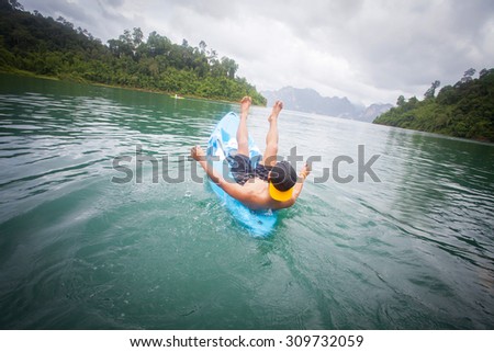 Kayaker so happy extreme sporting a kayak cuts through water with nature background
