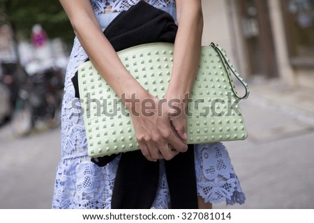 BERLIN - July 8, 2015: Stylish woman carrying a pastel green bag with rivets. Berlin Fashion Week Spring / Summer 2016