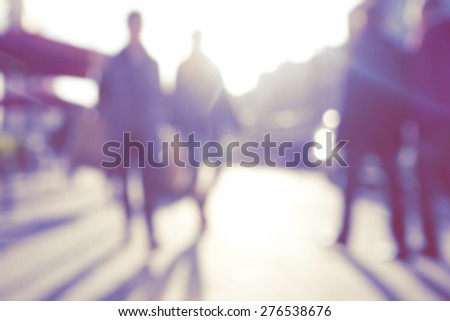 City commuters. High key blurred image of people walking in the street. Unrecognizable faces.