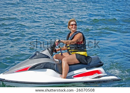 a woman enjoys a ride on a personal water craft on a beautiful summer day