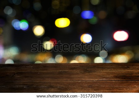 Empty wooden table  and bokeh at night.