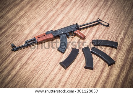 toy gun and weapons and toy scale on woods texture and woods backgrounds