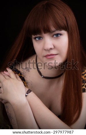 Portrait of red-haired girl with a rose tattoo