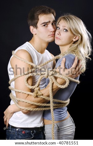 Frighten couple bound with ropes. Cord fastened by a bow