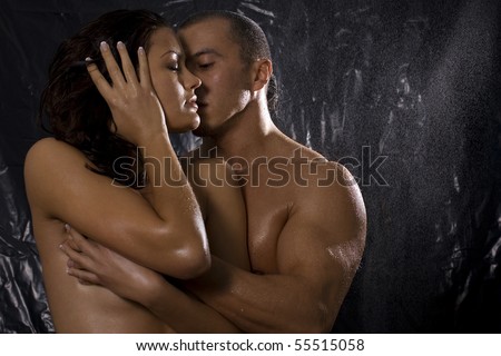 Loving affectionate nude heterosexual couple in shower engaging in sexual games, hugging and kissing
