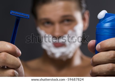 Sexy handsome young man with a shaving foam