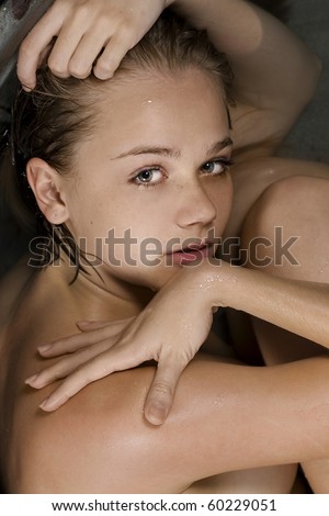 Conceptual photo of a woman curled up in a fetal position in the water.