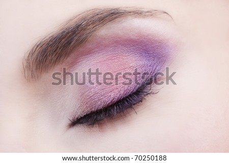 Woman beautiful eye with bright pink and violet makeup