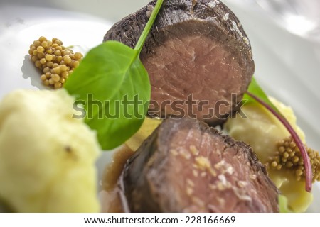 Beef tenderloin steak prepared la sous vide on Dijon mustard with homemade potato cream and olive oil