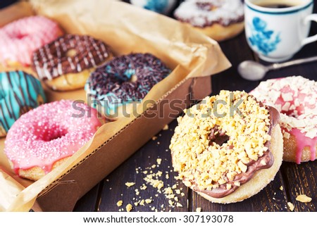 A box with fresh homemade donuts with various toppings.