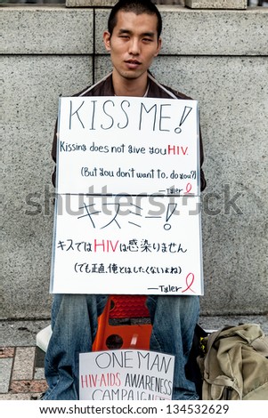 TOKYO-SEPT18: AIDS-HIV activist dispenses awareness information near Yoyogi Park, popular with teens and young adults on Sept. 18, 2009 in Tokyo. 20-30 year-olds have the highest rate of HIV in Japan.