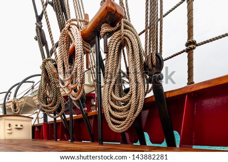 Coils of rope and rigging on the deck of a tall ship schooner at sea. Close up detail shot from a low angle looking up.