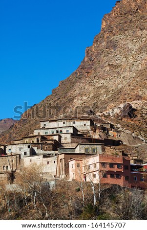 Tiny village built on the face of a steep mountain in Morocco. Bright blue sky with copy space.