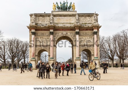 PARIS - JAN 5, 2014: The monument Arc de Triomphe du Carrousel in the Tuileries Gardens, a popular tourist destination near the Louvre Museum. Built 1806-1808 to honor Napoleon\'s military victories.