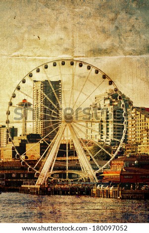 Seattle ferris wheel, space needle, waterfront and skyline toned with vintage color,textures and folded paper creases. Copy space.