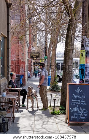 SEATTLE-APR 15, 2014: Coffee drinkers at a sidewalk cafe in Ballard, a popular neighborhood in Seattle known for its historic architecture and a growing scene of hip restaurants, bars and shops.