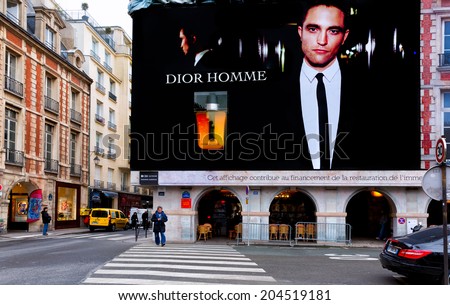 PARIS-DEC 23,2013: Dior Homme perfume billboard dominates a corner at Place des Vosges, the oldest square in Paris. Dior calls the scent the distinguished mark of a man with uninhibited elegance.