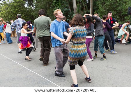 SAN FRANCISCO-JULY 13, 2014:Swing dancing in Golden Gate Park, a weekly Sunday tradition that includes a lesson.The free event attracts all ages, couples and people willing to dance with strangers.