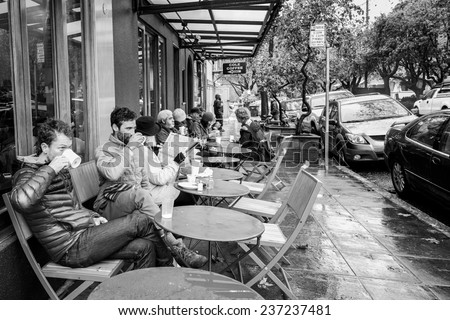 OAKLAND, CA-DEC 11, 2014: Coffee drinkers at a sidewalk cafe in the north Oakland neighborhood of Rockridge, an area known for cafes and upscale restaurants.