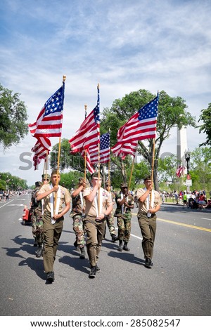 WASHINGTON DC-May 25, 2015: Active duty troops march in the Memorial Day Parade. The Washington monument can be seen in the background.