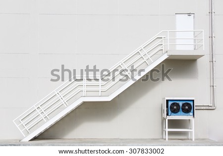 White clean metal stairs on concrete wall