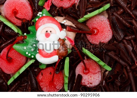 Santa Claus doll on top of iced cake
