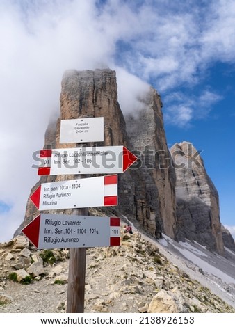 Mountain paths signs at the 3 Cime di Lavaredo. Red and white sign to direct hikers towards their destination. Summer time. Trail signs with the background of the Tre cime di Lavaredo. Dolomites Italy Stok fotoğraf © 