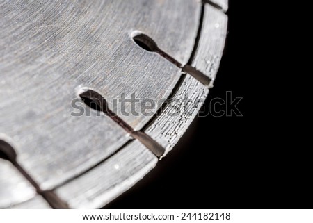 Cutting disk with diamonds, on black background.