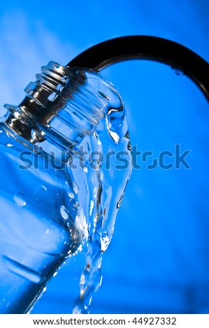 Pure water pouring in the plastic bottle from the water crane