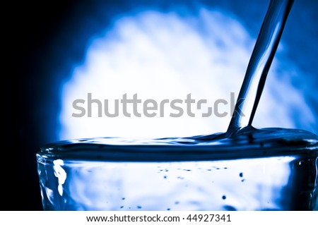 The stream pure water flows in a glass