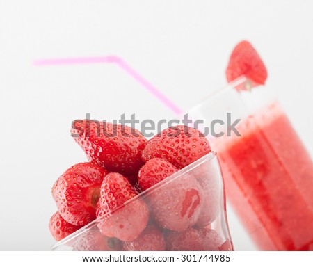 glass of strawberry juice and strawberries