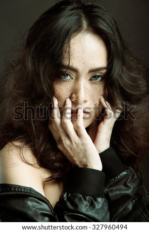 Young beautiful freckles woman face portrait with healthy skin