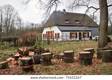 Traditional Dutch farm house with wood logs for the winter