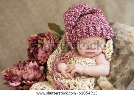 A beautiful sleeping baby girl wearing a hat with a vintage look, soft focus