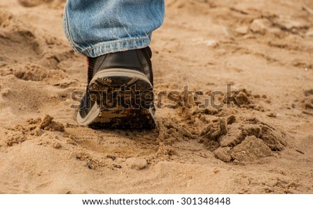 Human walking outdoors on a sandy shore