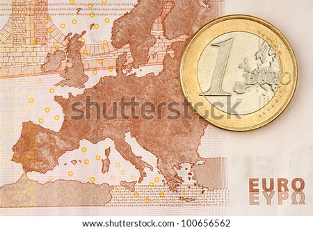 One Euro Coin on Euro Banknote showing Map of Europe