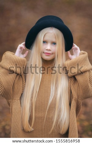 Similar – Image, Stock Photo Little blonde sweet girl is noodles with tomato sauce and smears her face with red sauce with her hand, she holds the small spoon in her hand, over a bowl and looks curiously into the camera, at home in the apartment.