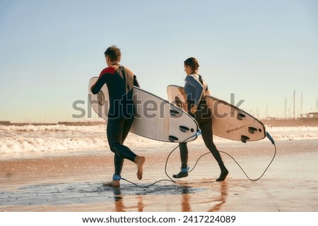 Similar – Image, Stock Photo Surfer entering into the water with his surfboard.