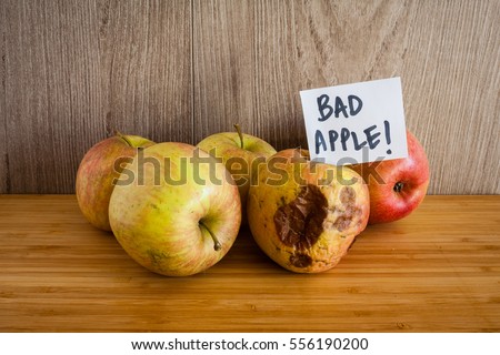 One ugly apple in front of four good apples and the rotten apple  with a white card that says bad apple! Сток-фото © 