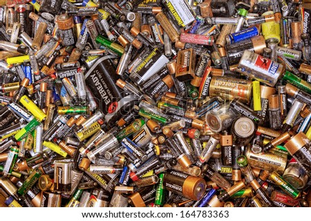 FAIRFAX, VA - NOVEMBER 21: Different types of used batteries lying in a heap at a recycling center on November 21, 2013 in Fairfax, VA. Types are AAA, AA, 9-volt and super heavy duty.