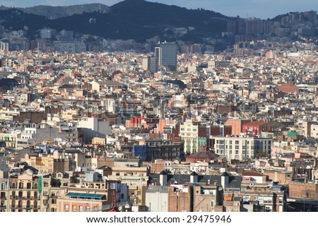 Panoramic overview of Barcelona\'s Urban density some high rises and mountain in the back