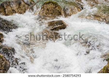 Similar – Foto Bild Schneller Wasserfall, der unter dem Sternenhimmel in der Abenddämmerung durch Felsen fließt