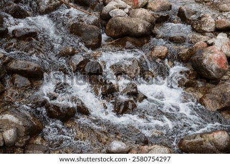 Similar – Foto Bild Schneller Wasserfall, der unter dem Sternenhimmel in der Abenddämmerung durch Felsen fließt