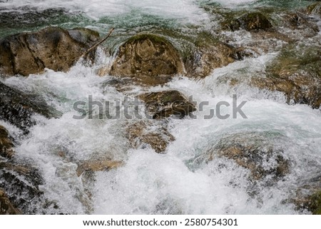 Similar – Foto Bild Schneller Wasserfall, der unter dem Sternenhimmel in der Abenddämmerung durch Felsen fließt