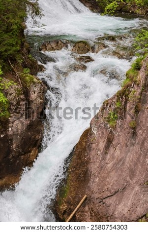 Similar – Foto Bild Schneller Wasserfall, der unter dem Sternenhimmel in der Abenddämmerung durch Felsen fließt