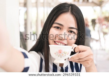 Beautiful Women drinking hot tea in cafe.Morning time.Drinking tea concept.Relax time.