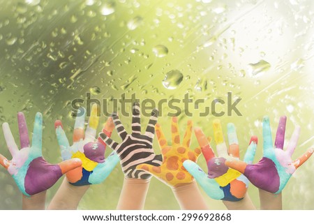 Hand Painted Child. Isolated on white background.animal hand paint concept.giraffe and zebra hand paint on window with water drop background.